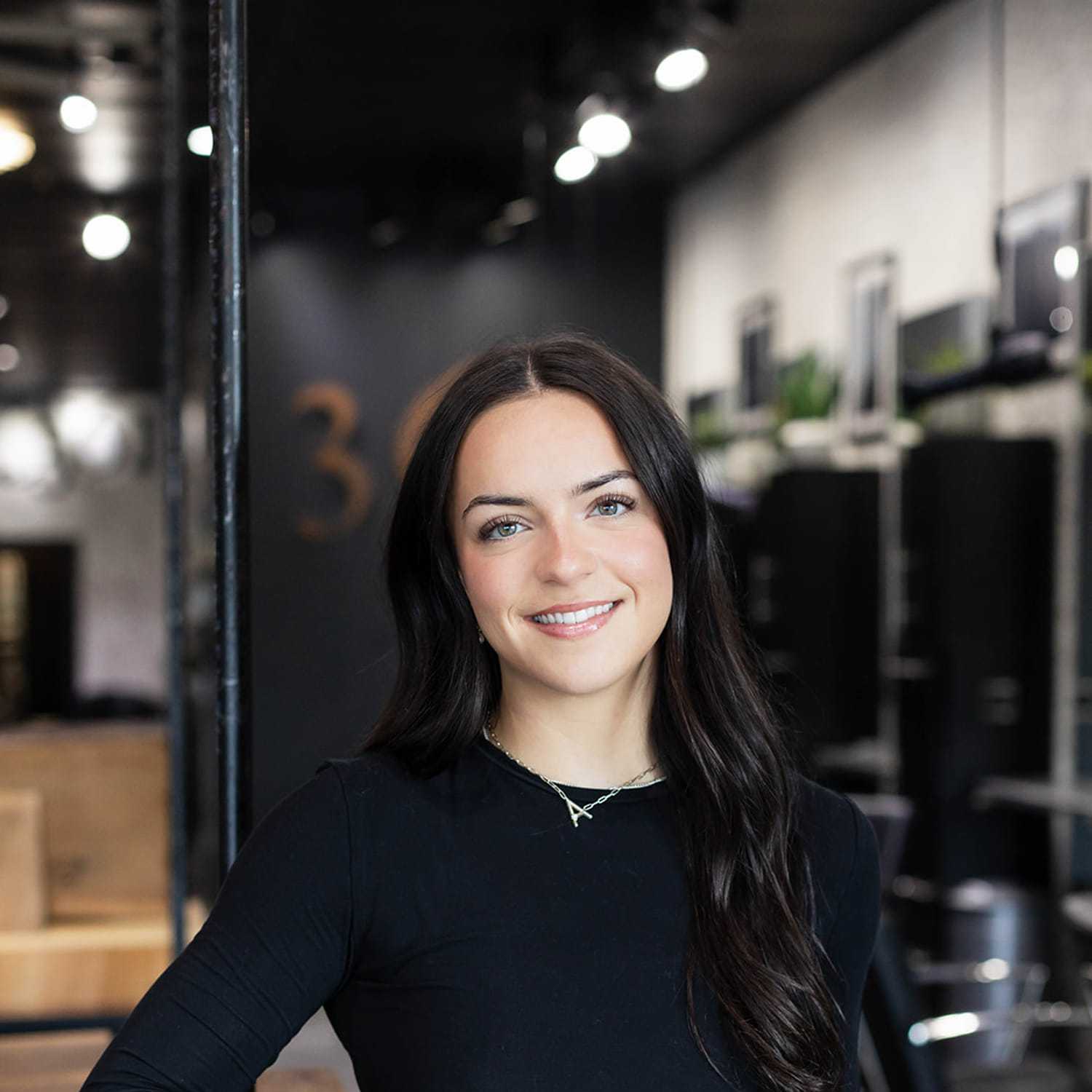 Portrait of Aspen Maggard, a professional stylist at Salon361, showcasing their expertise and style.