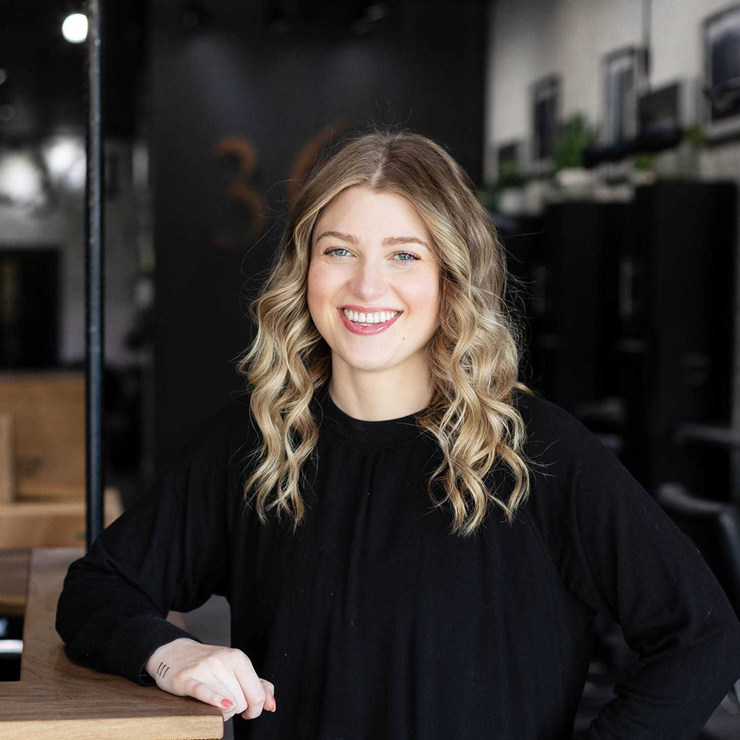 Portrait of Taylor Shoewalter, a professional stylist at Salon361, showcasing their expertise and style.