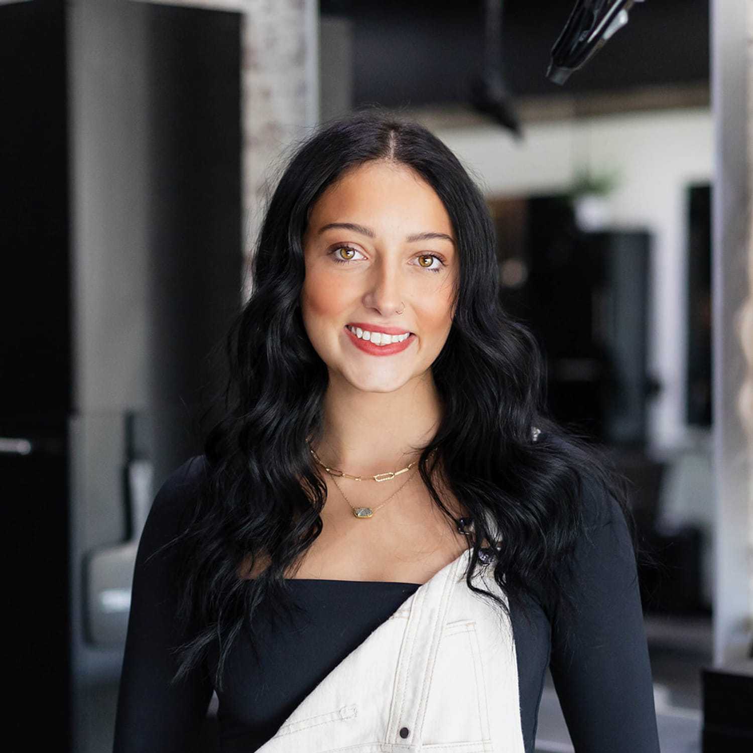 Portrait of Ava Springer, a professional stylist at Salon361, showcasing their expertise and style.