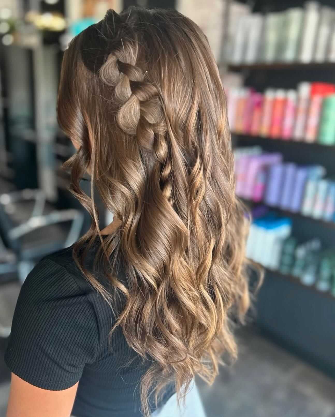 Hair with braided crown and loose curls in a salon setting.